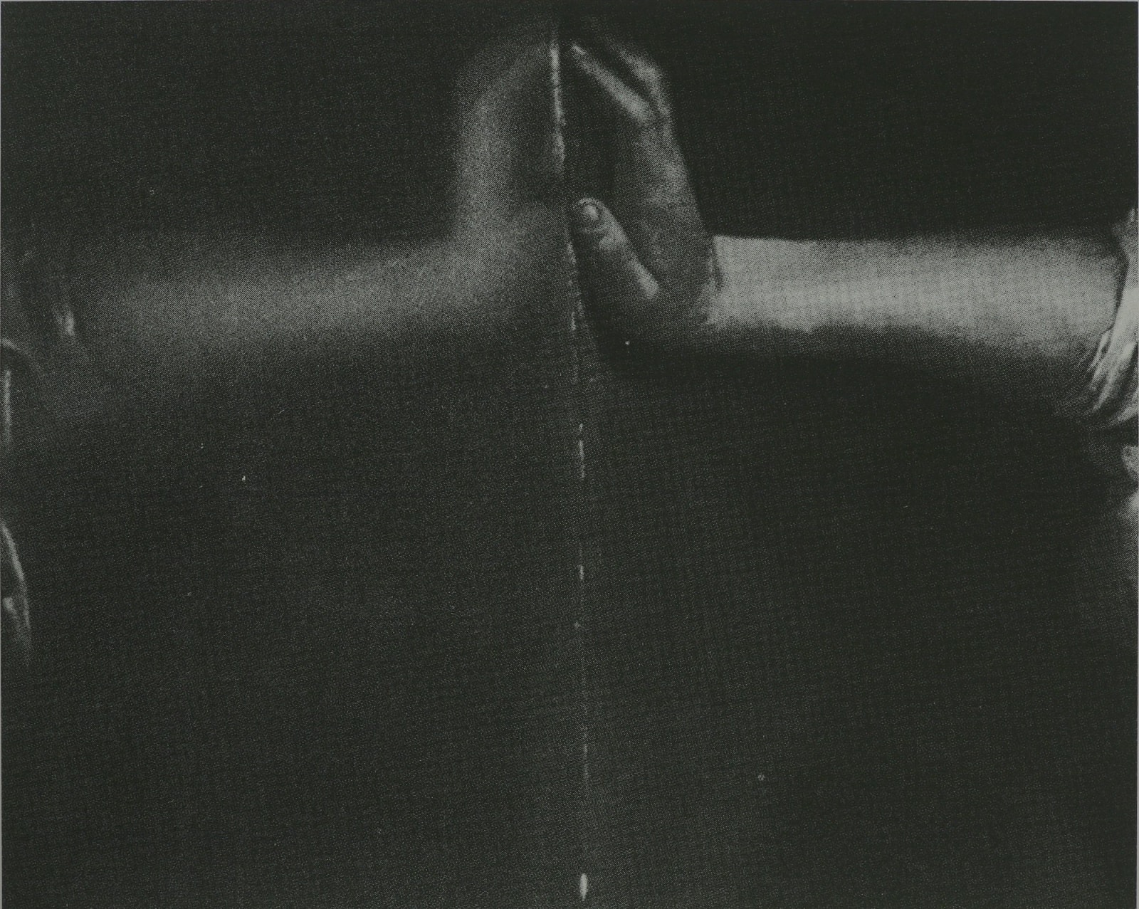 Black and white photograph of two hands touching palm to palm