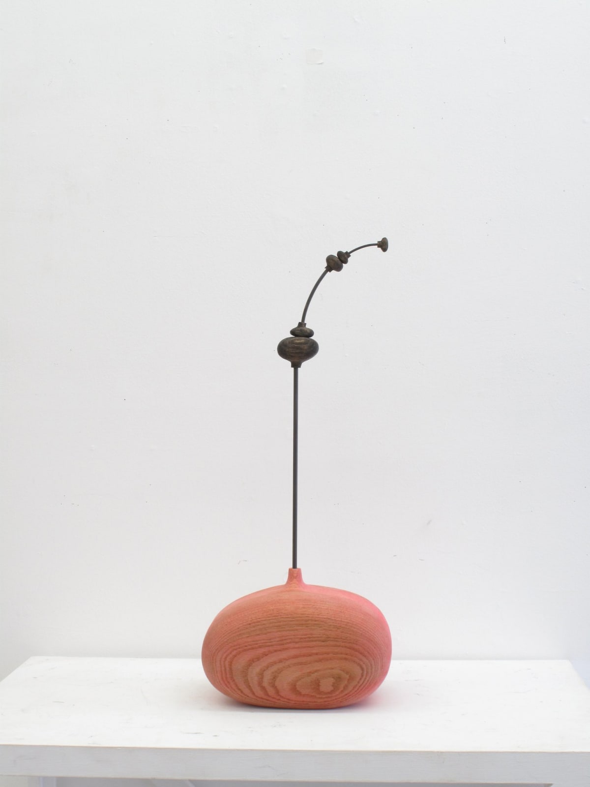 Carved wood sculpture with cartoon anatomical elements