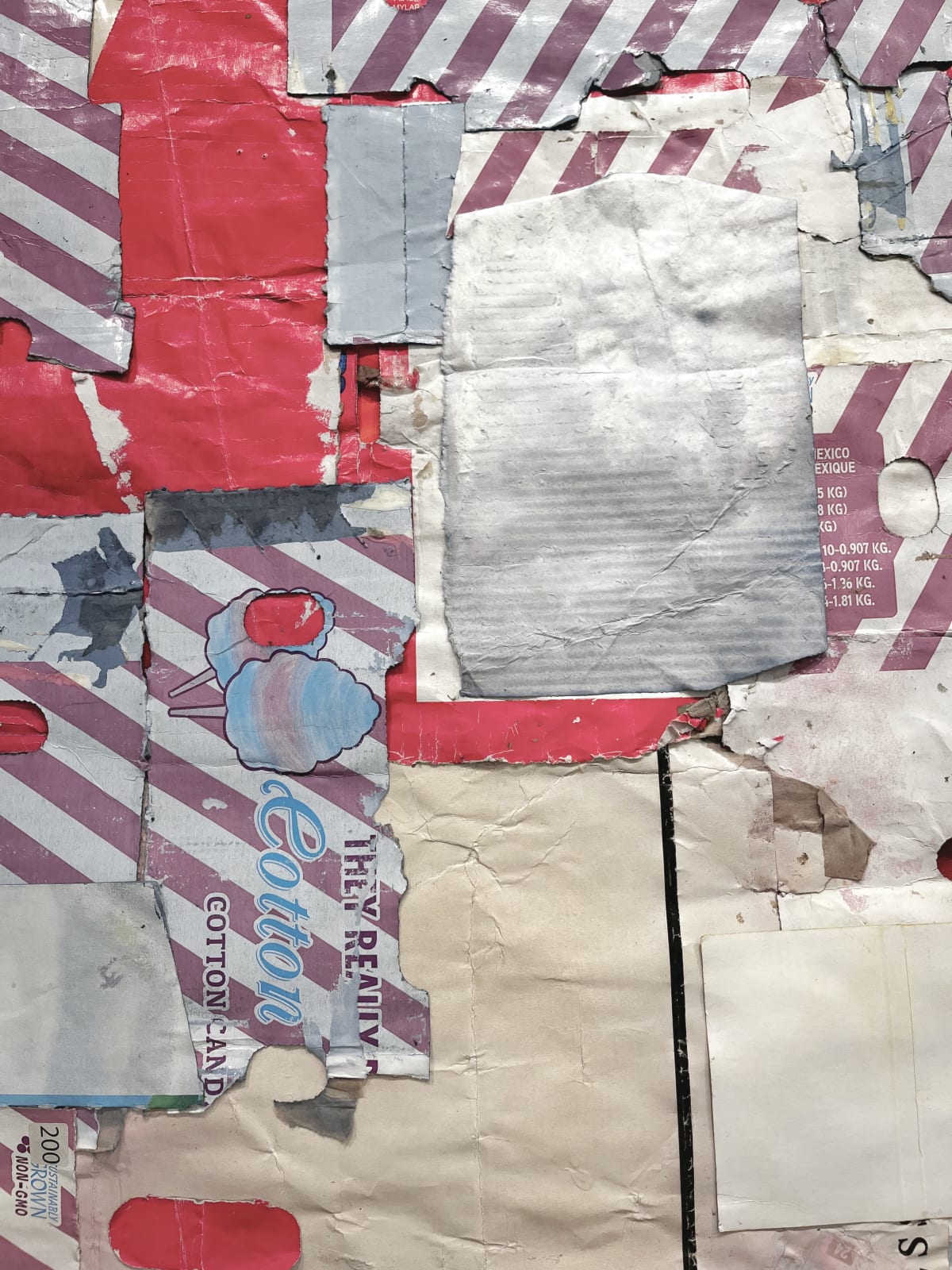 Close-up of cardboard assemblage that resembles an abstract quilt with stripes and irregular pieces