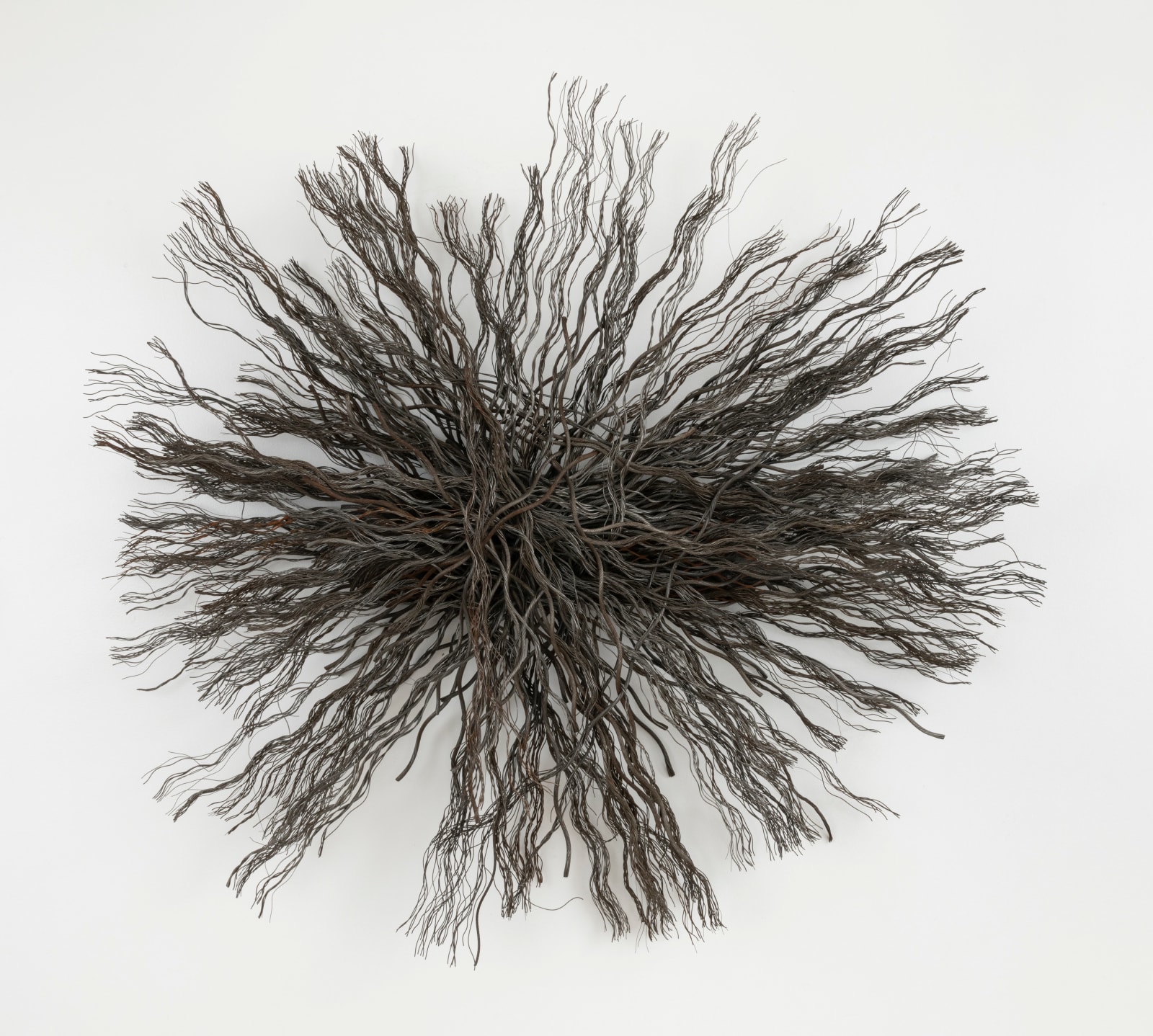 Artwork composed of a circular starburst shaped bundle of wire rope