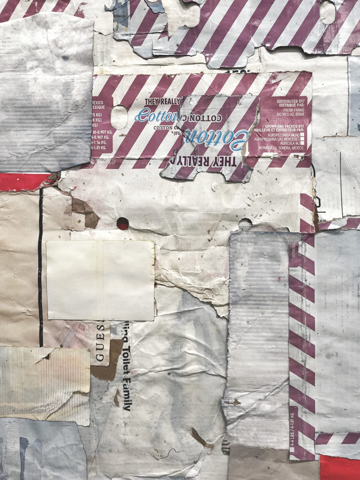 Close-up of cardboard assemblage that resembles an abstract quilt with stripes and irregular pieces