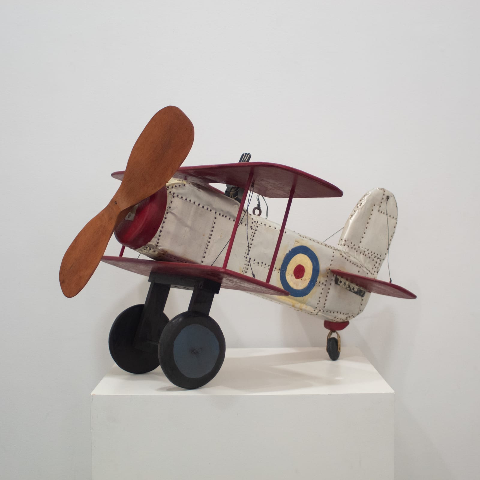 Sculpture of biplane made of wood and tin
