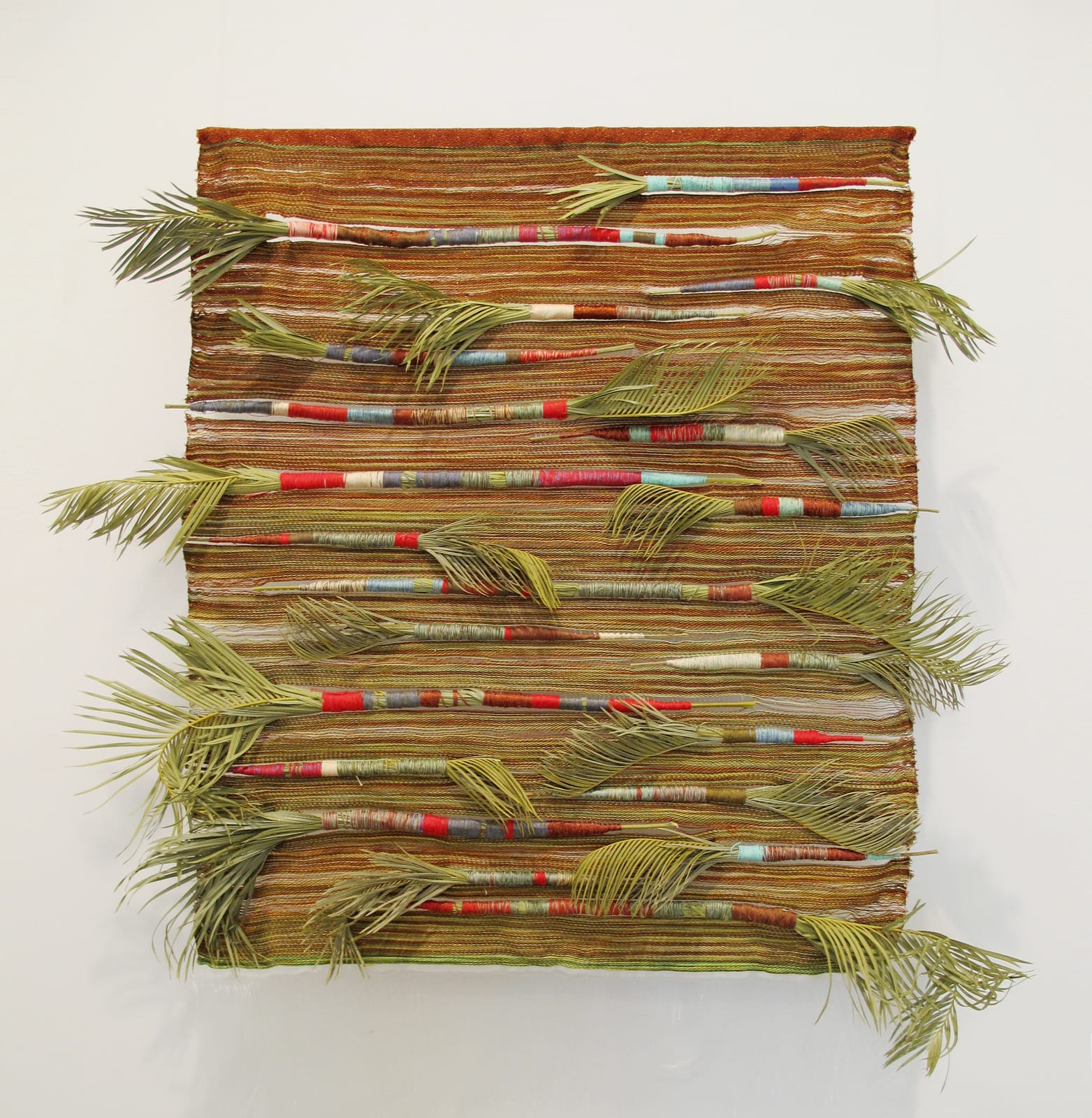 Woven wall hanging with plant fronts