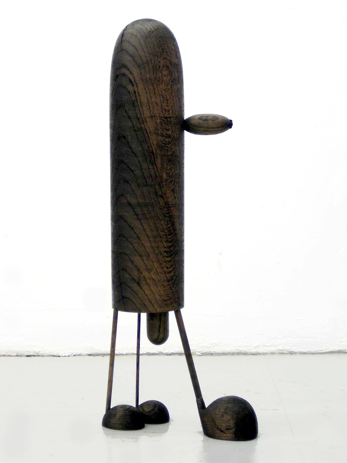 Carved wood sculpture with cartoon anatomical elements