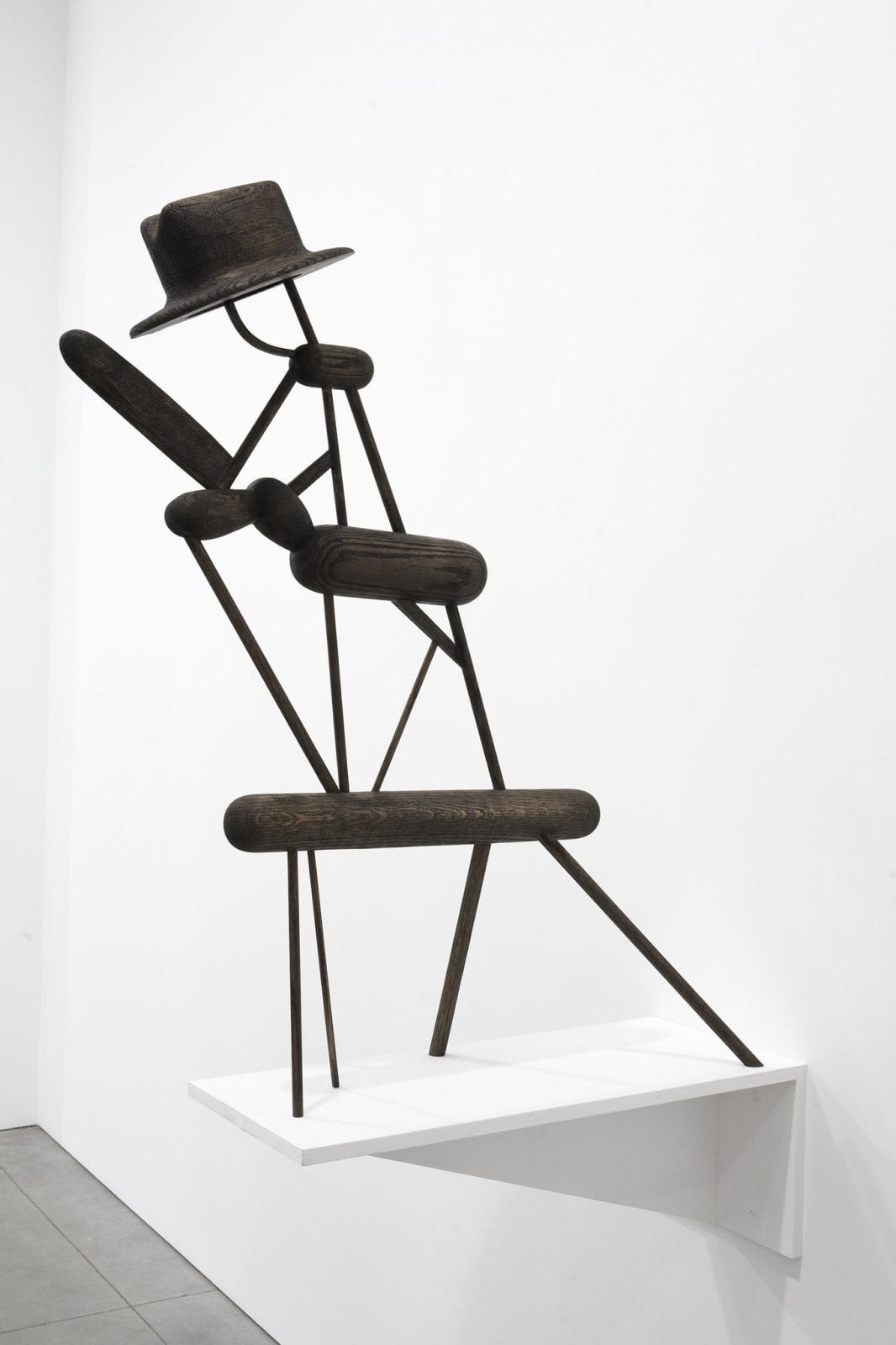 Carved wood sculpture with cartoon anatomical elements