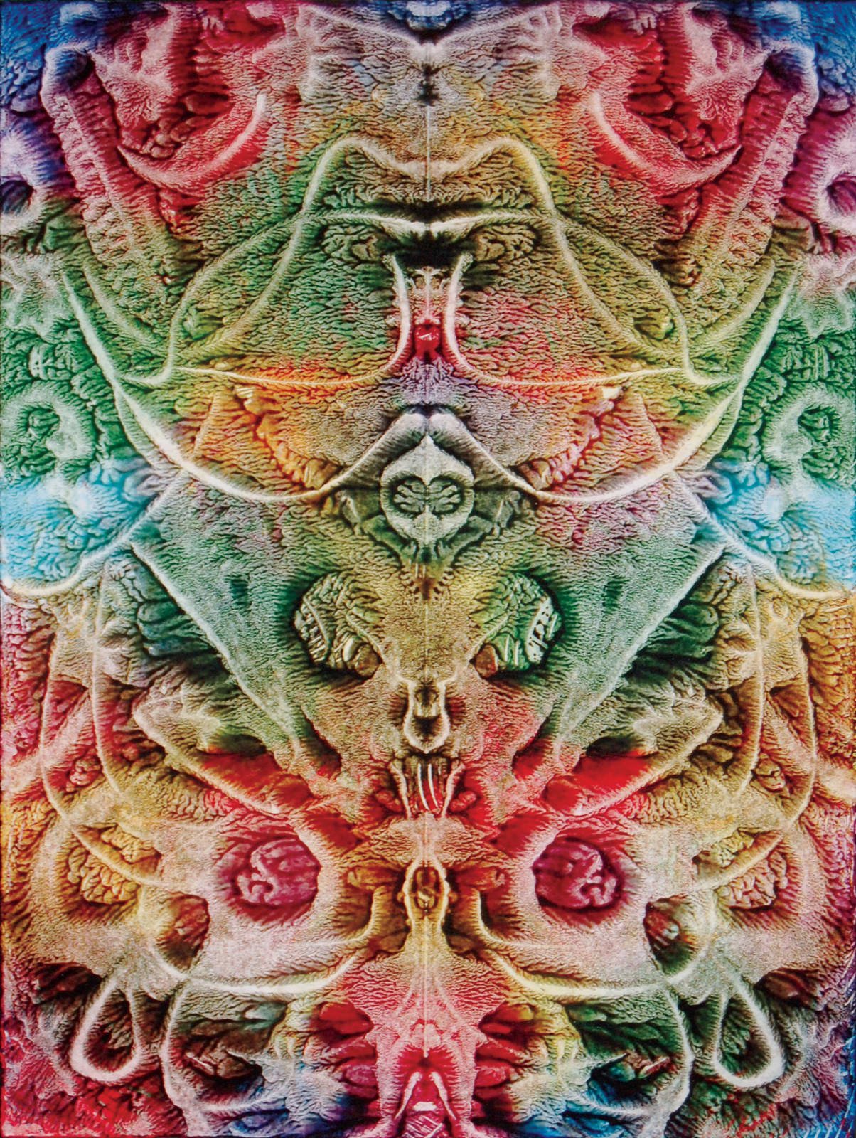 Print, rorschach-like image of arabesques and stamped monkey heads in red, blue, green, yellow ink