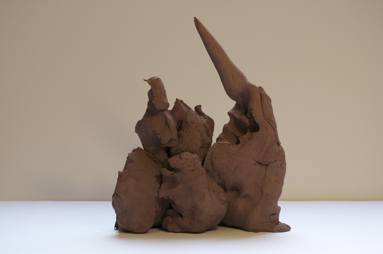 Abstract terracotta sculpture with triangular peaks
