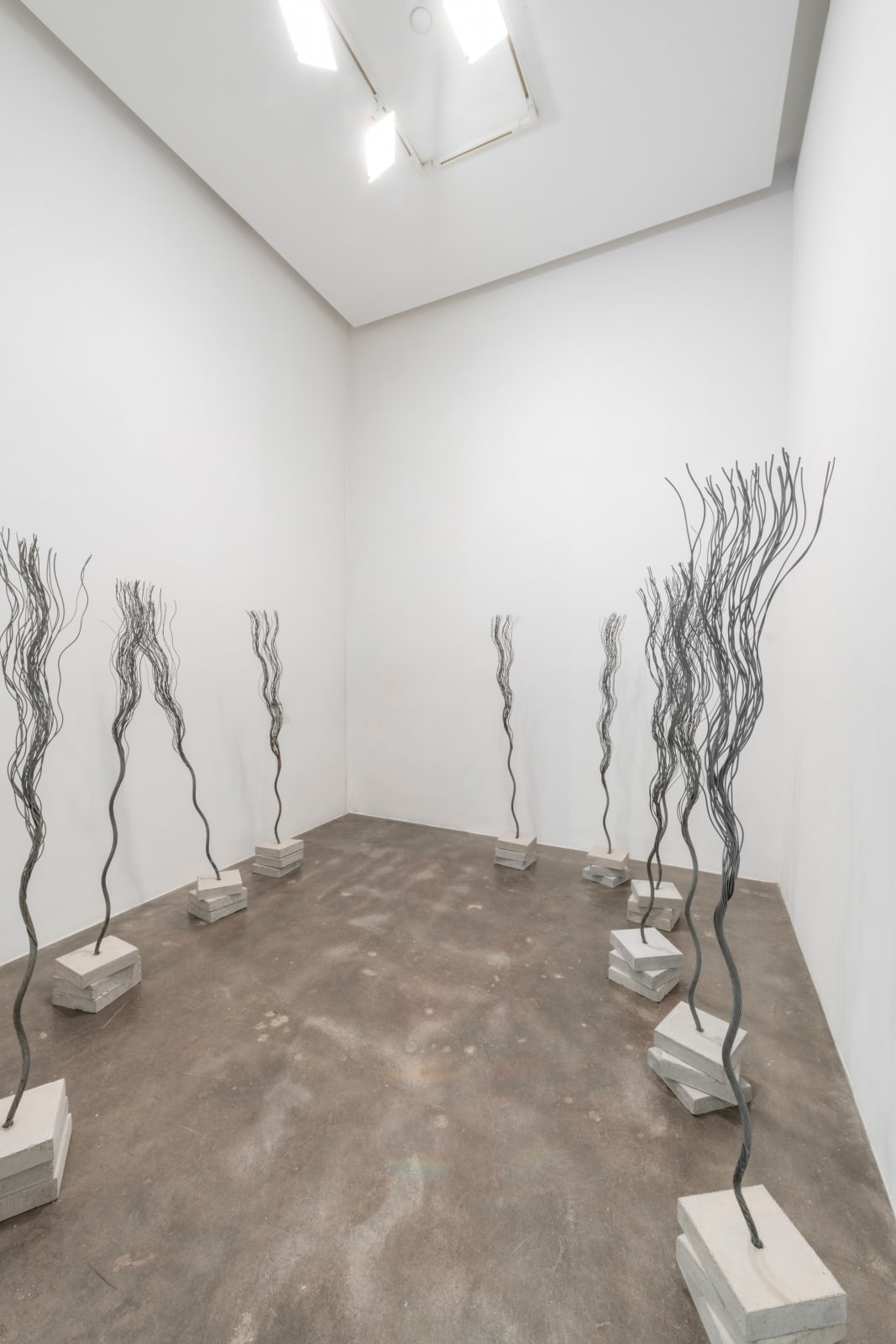 Wire rope twisted to look like trees embedded in stacked concrete bases