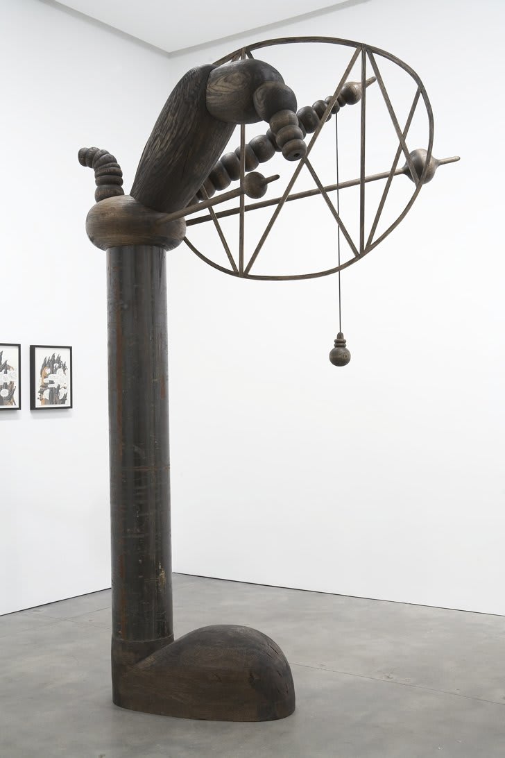 Large vertical sculpture that appears to be wearing a shoe