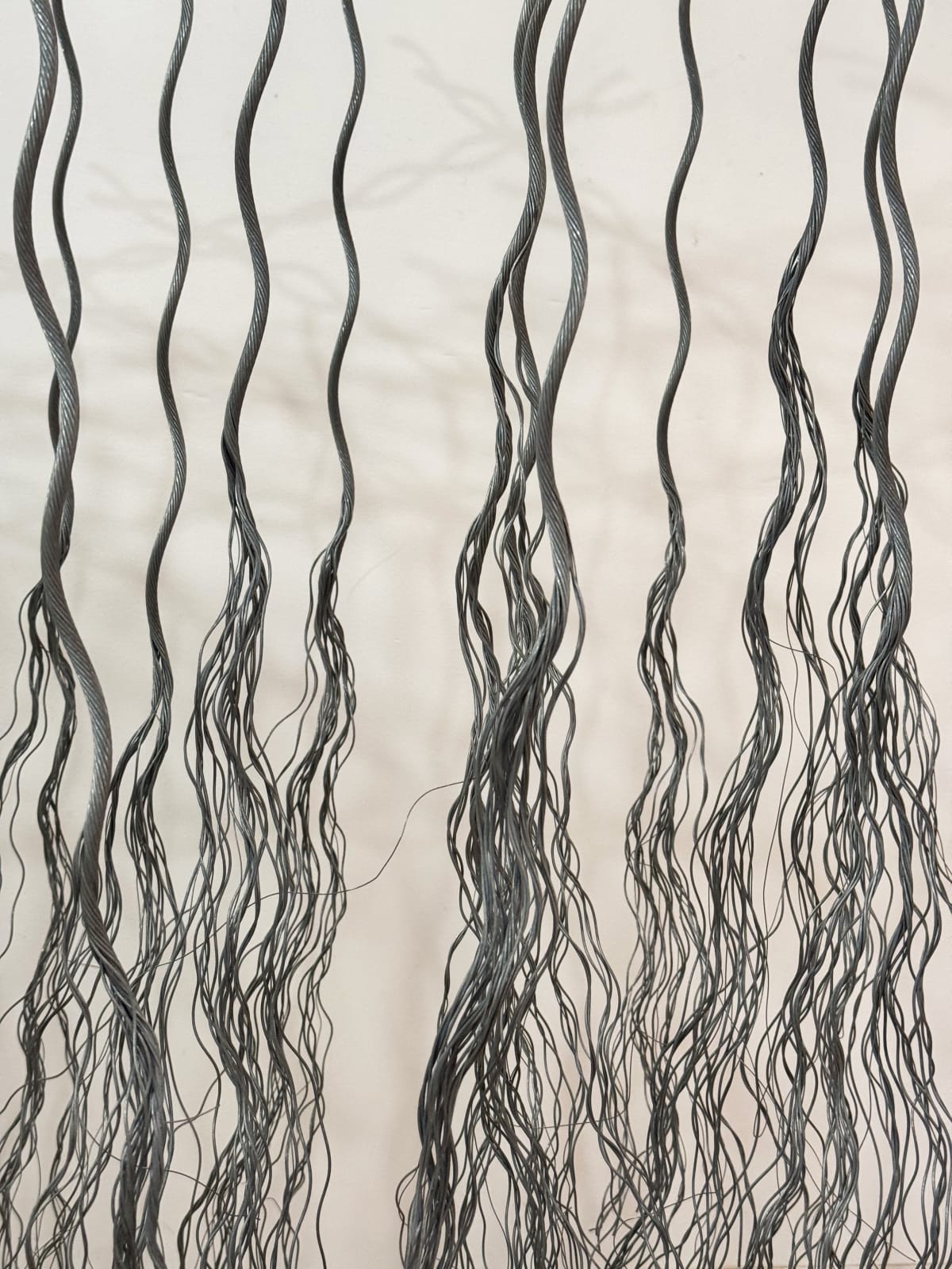 Detail of bundles of wire rope hanging from wire net