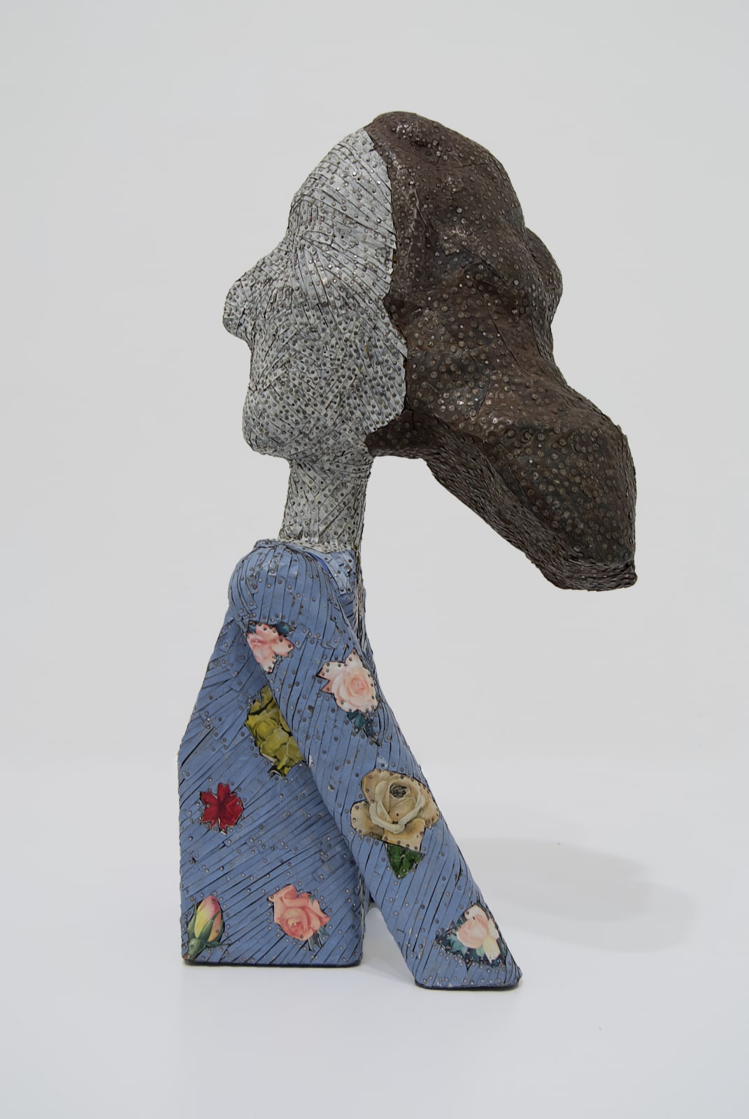 Side view of female bust made from strips of colored tin