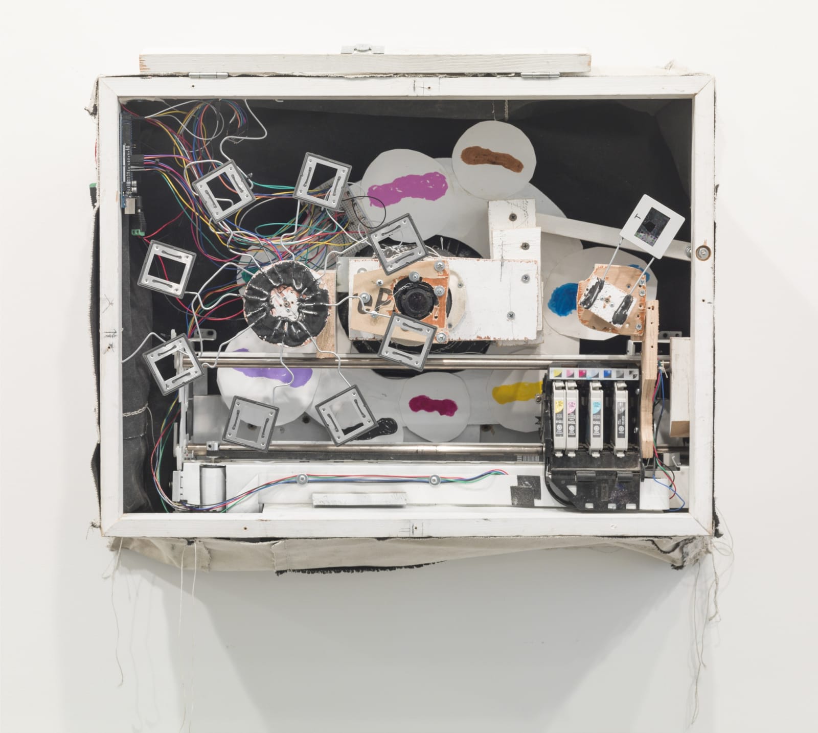 Abstract sculpture of white rectangle with multi colored elements inside