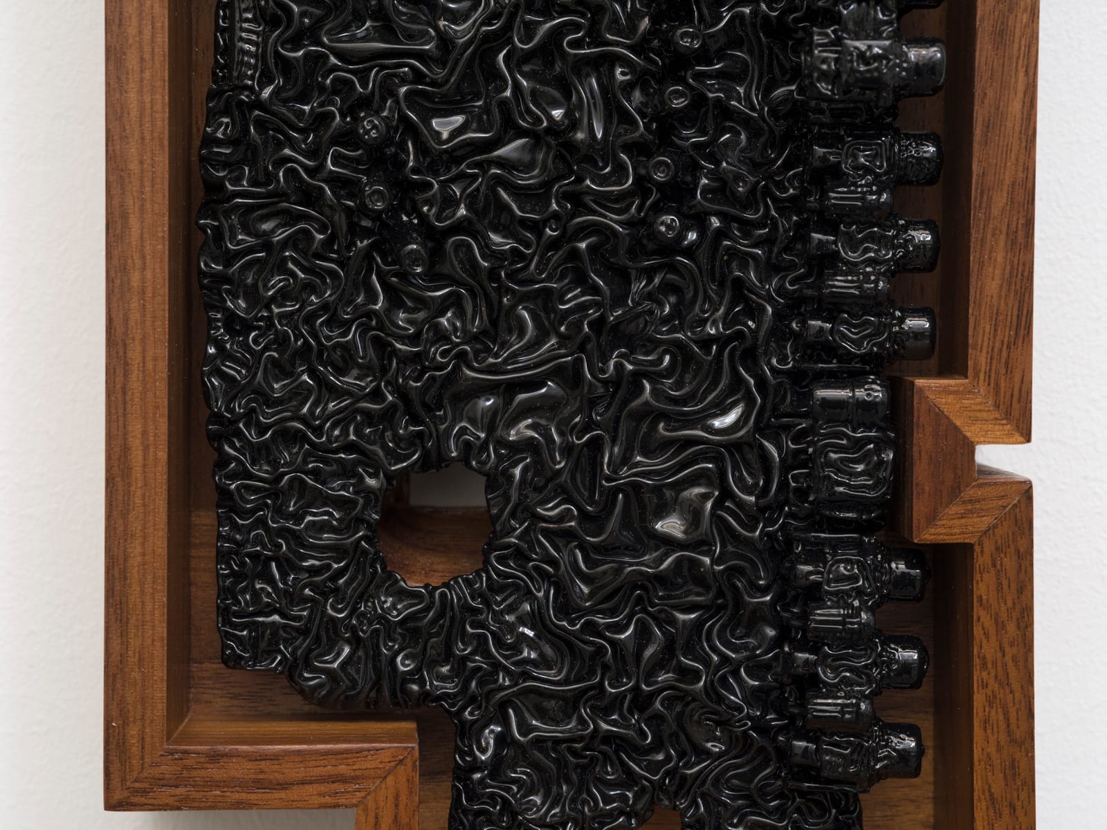 a detail of an ink of computer circuit board sculpture on a white wall