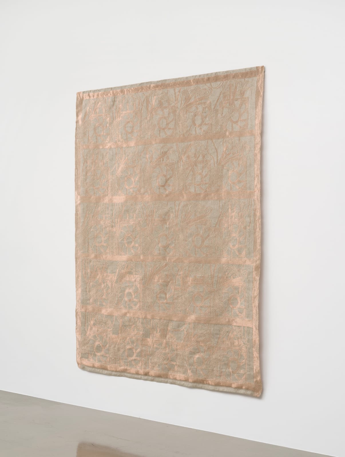 a slightly shimmery large scale copper weaving on a white wall