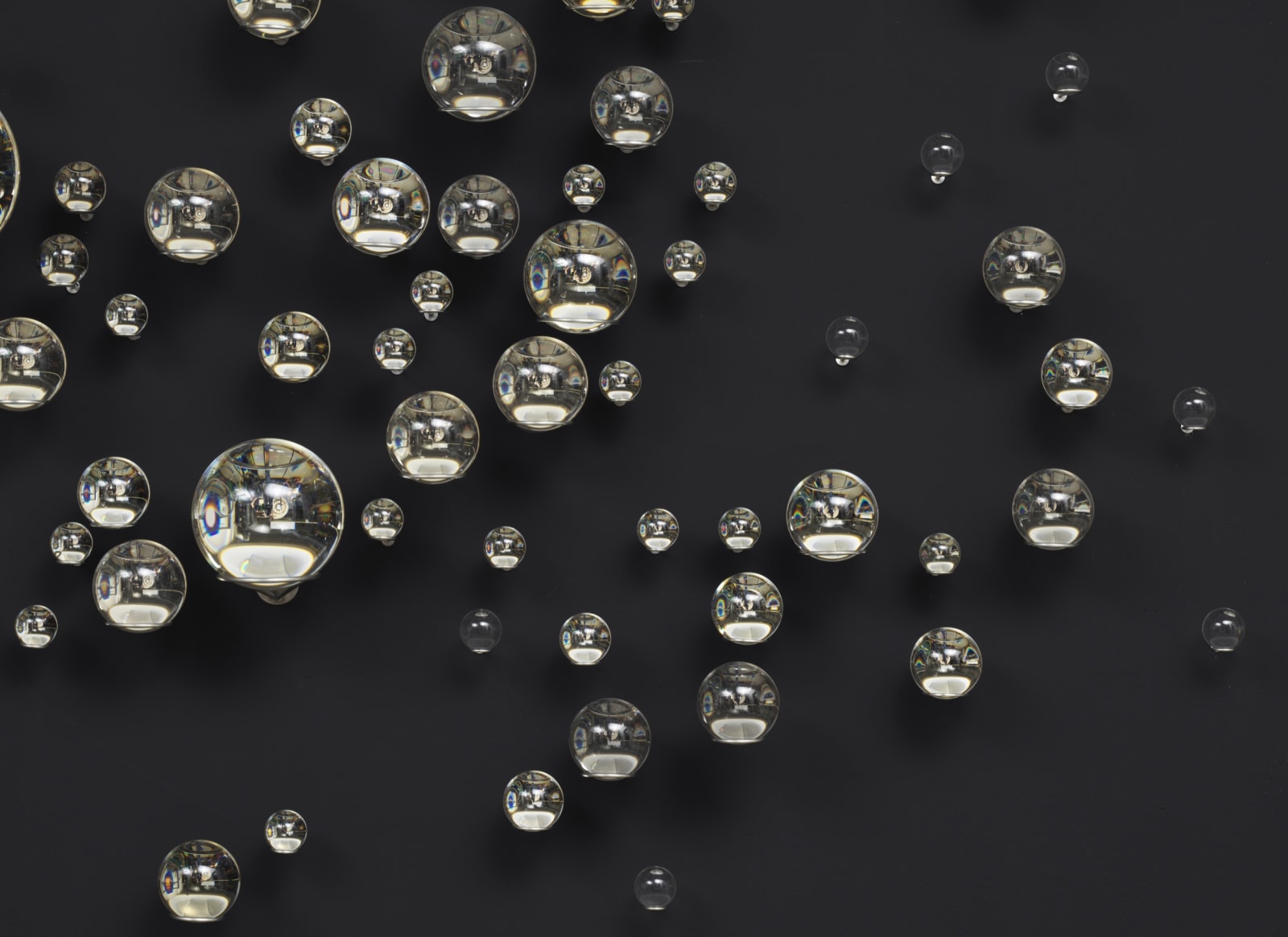 Eliasson crystal sphere sculpture on black wall