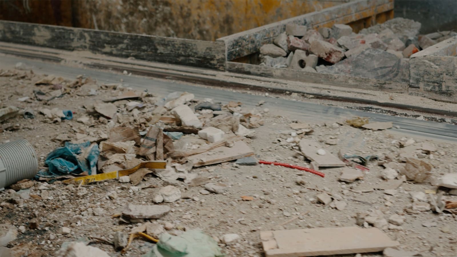 Karyn Olivier's Drift (Tributary), a video still of recyclables and debris on a conveyer belt