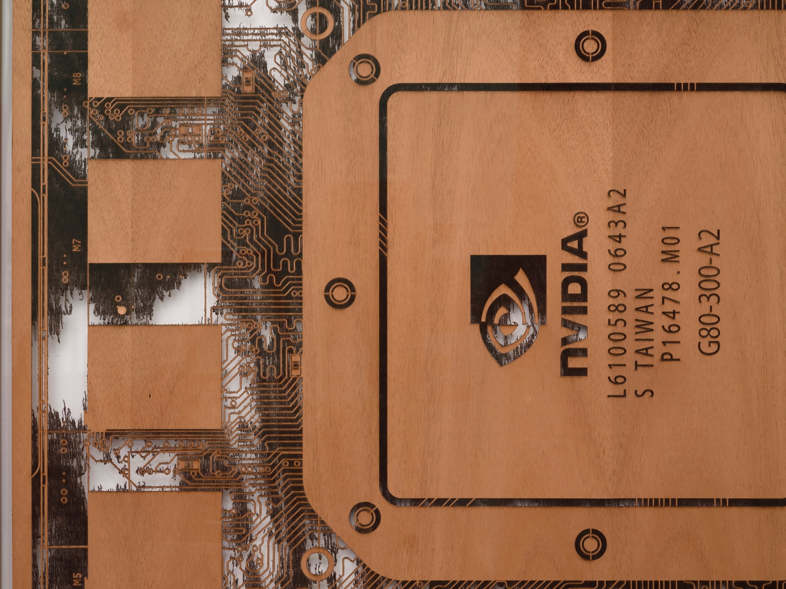 a detail of a laser sculpted wood sculpture on a white wall