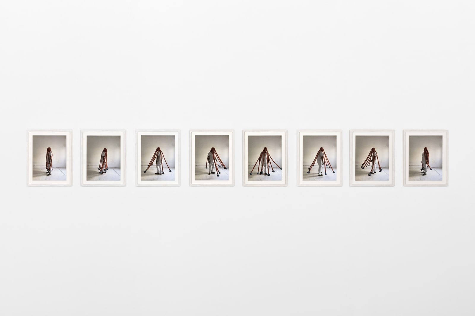 Photo series of Neto wearing sculpture