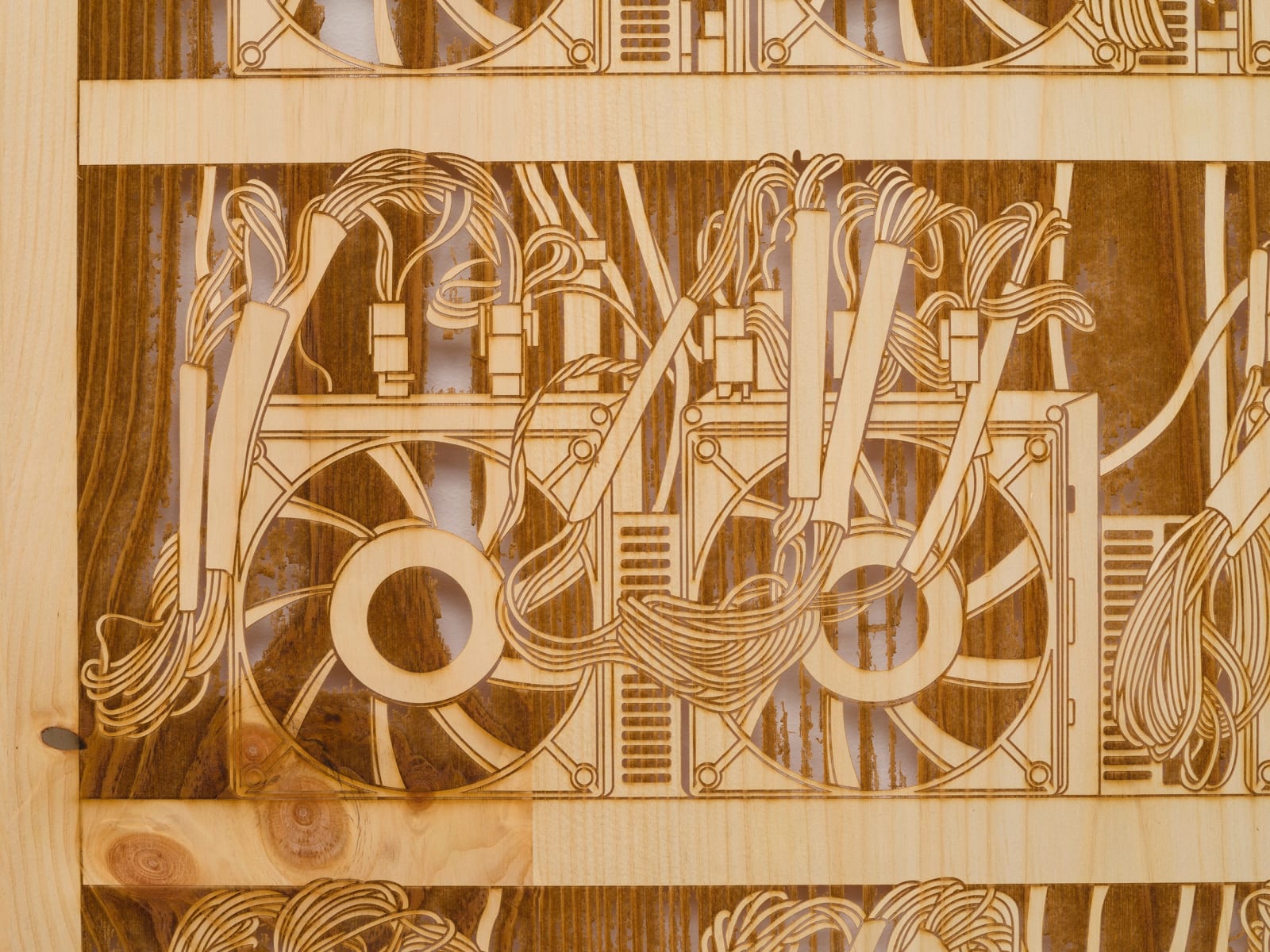 a detail of a laser sculpted wood sculpture on a white wall