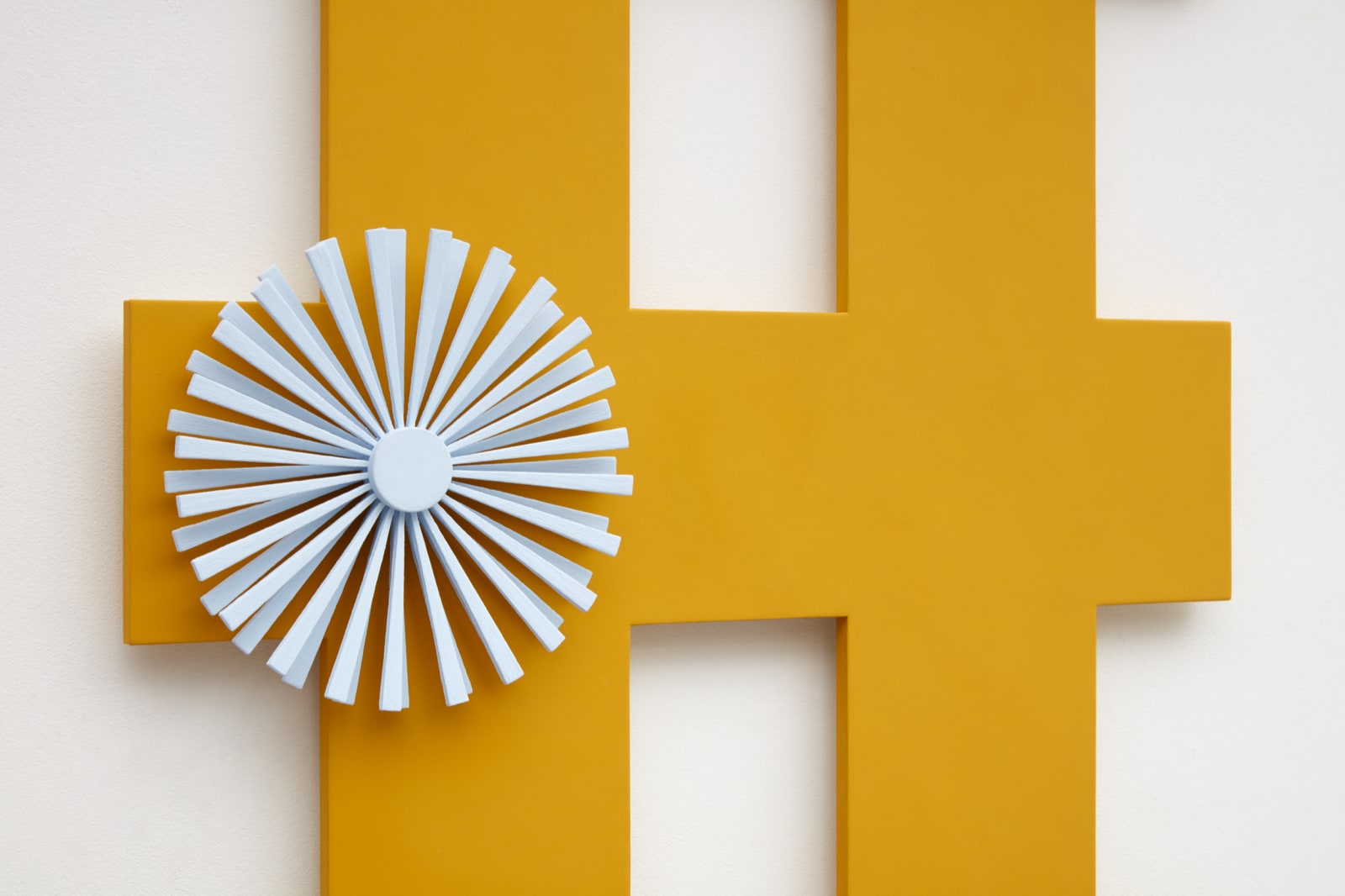 orange criss cross wall sculpture