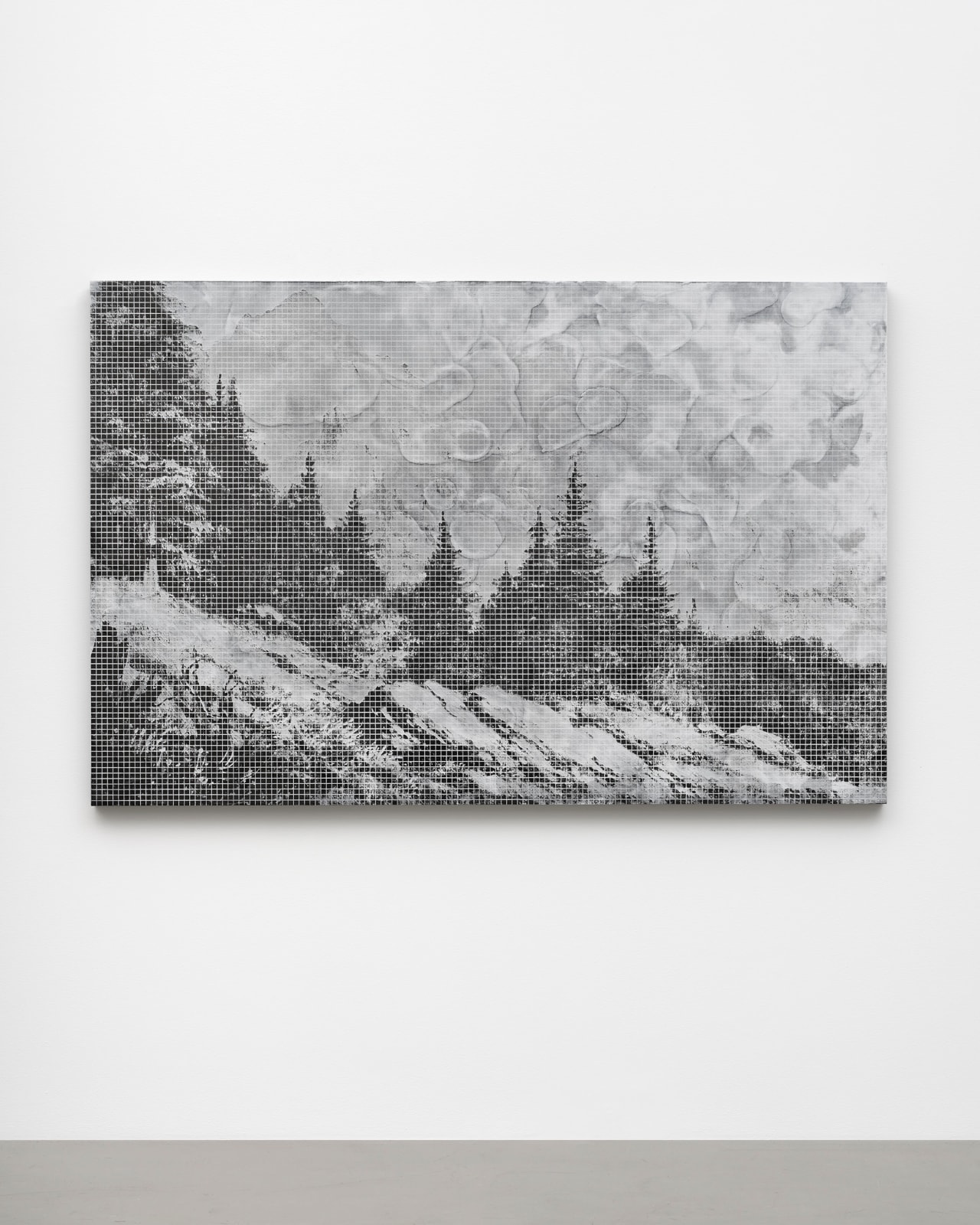 a black and white forest landscape on a small panel on a white wall