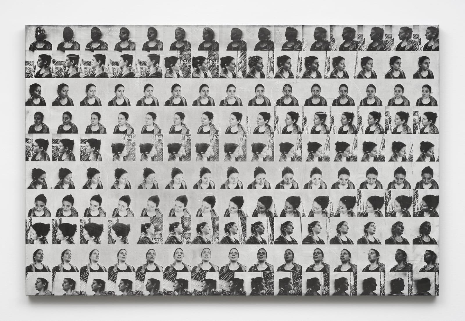 a grid of faces in black and white on a panel