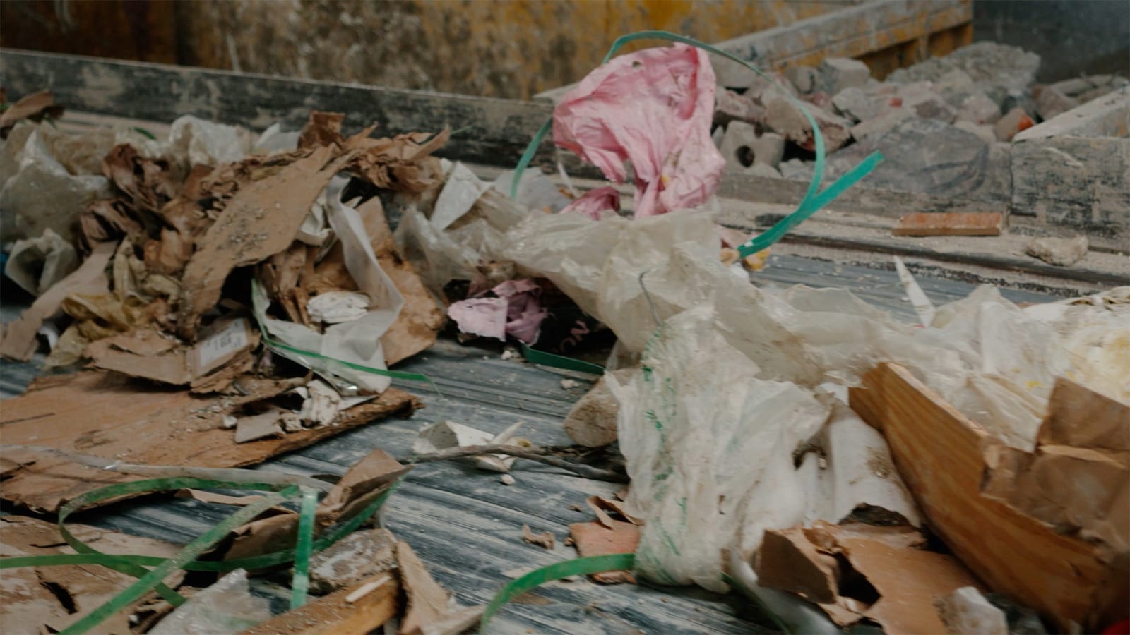 Karyn Olivier's Drift (Tributary), a video still of recyclables and debris on a conveyer belt