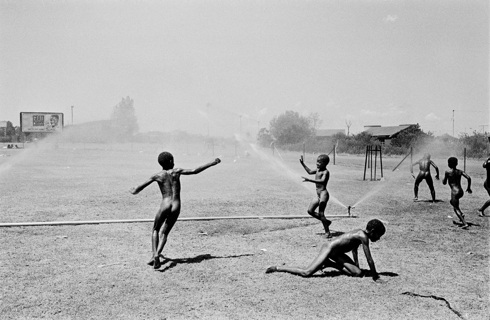 Ernest Cole, Children play with Sprinklers, circa 1965