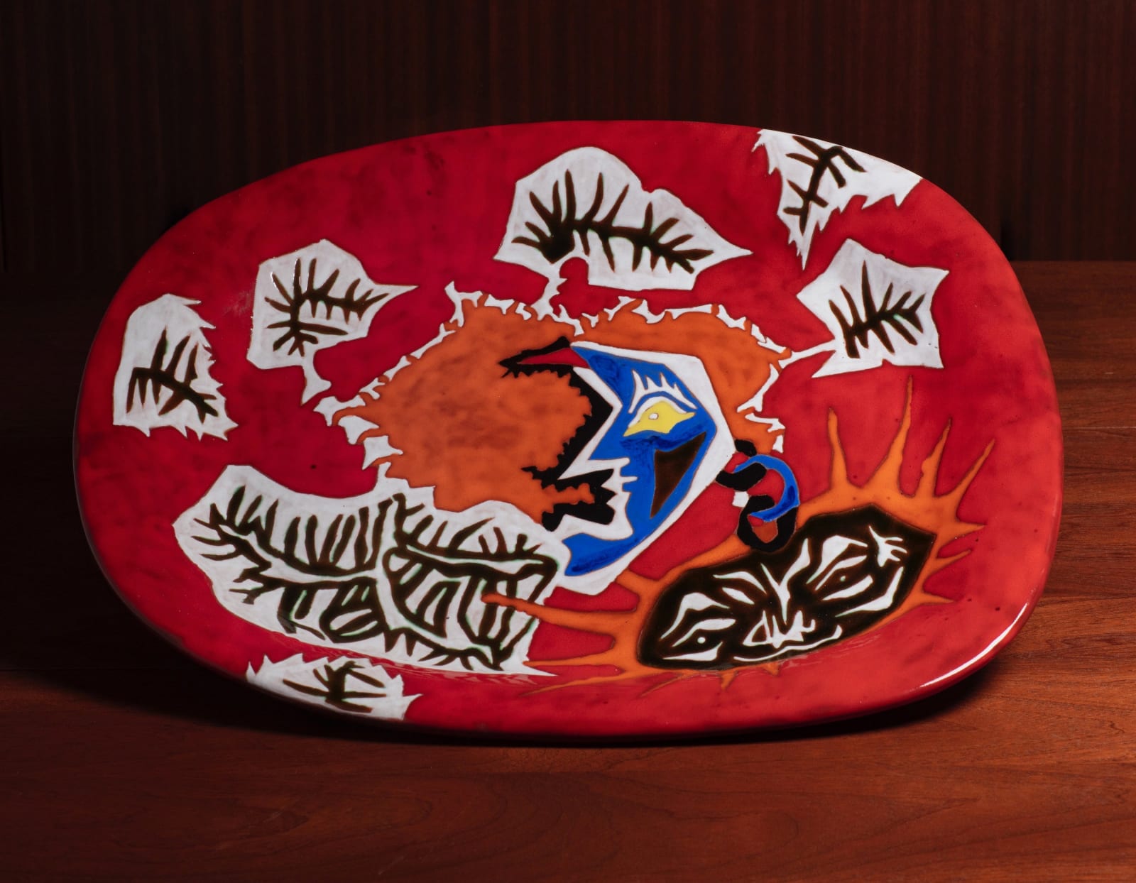 Jean Lurçat, Important red ceramic platter, for Sant-Vicens, France (composition with face and leaves), 1950