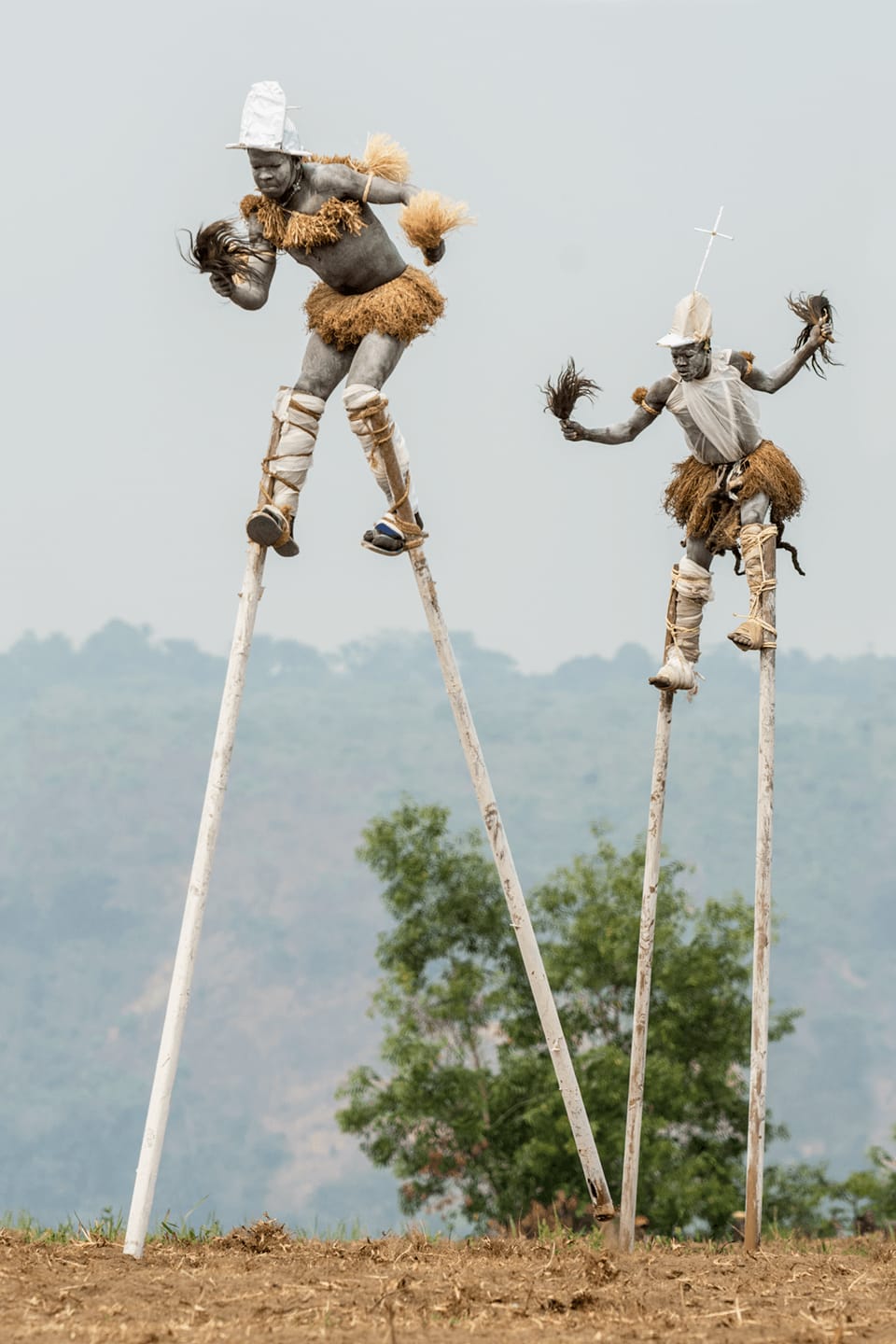 Carol Beckwith and Angela Fisher, Pende "Tall Men Walking" Stilt Dancers, Gungu, DR Congo, 2014