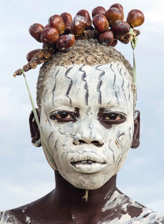 Carol Beckwith and Angela Fisher, Kara Boy with Chalk Make up and Berry Adornment, Omo River, Ethiopia, 2013