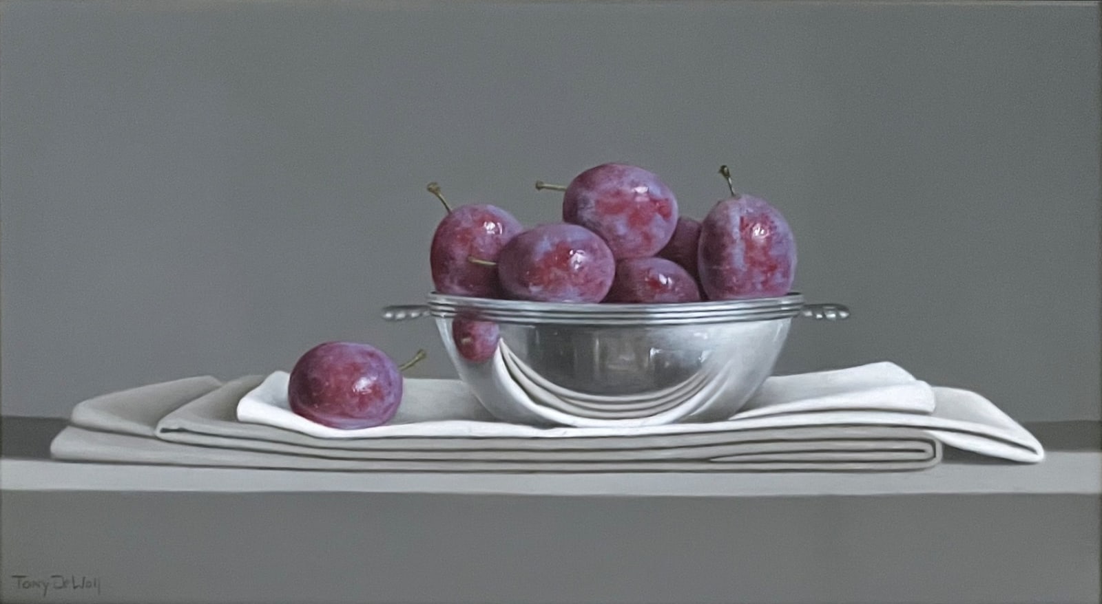Tony de Wolf, Blue Plums in Silver Bowl on folded Linen