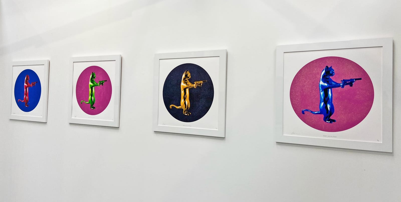 Gold & black rebel with the paws cat glitter sculpture print holding guns framed on the wall