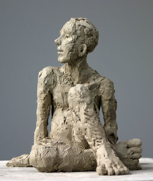 Seated Male figure iron resin sculpture