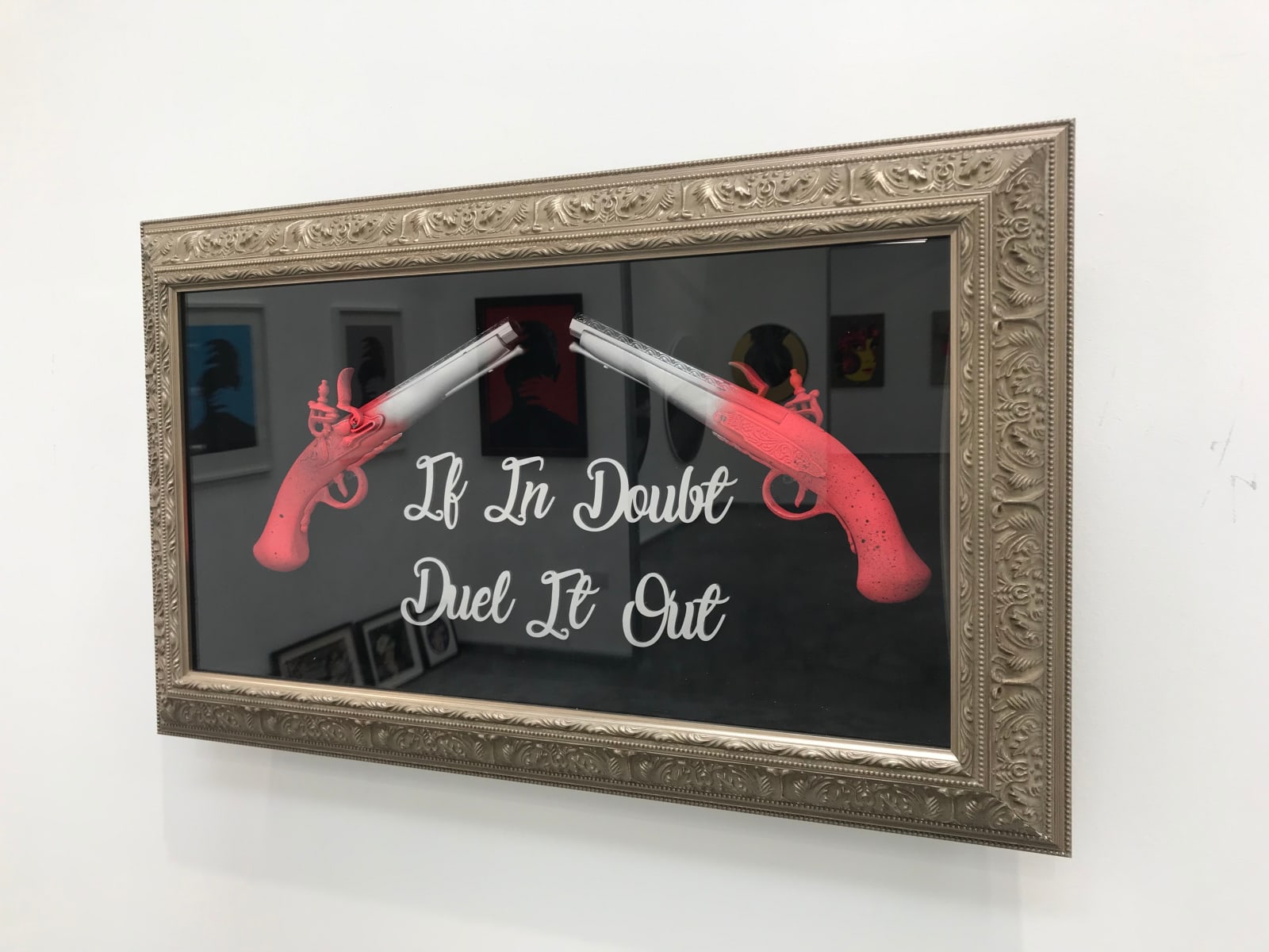 Red & silver duelling pistols in gold frame