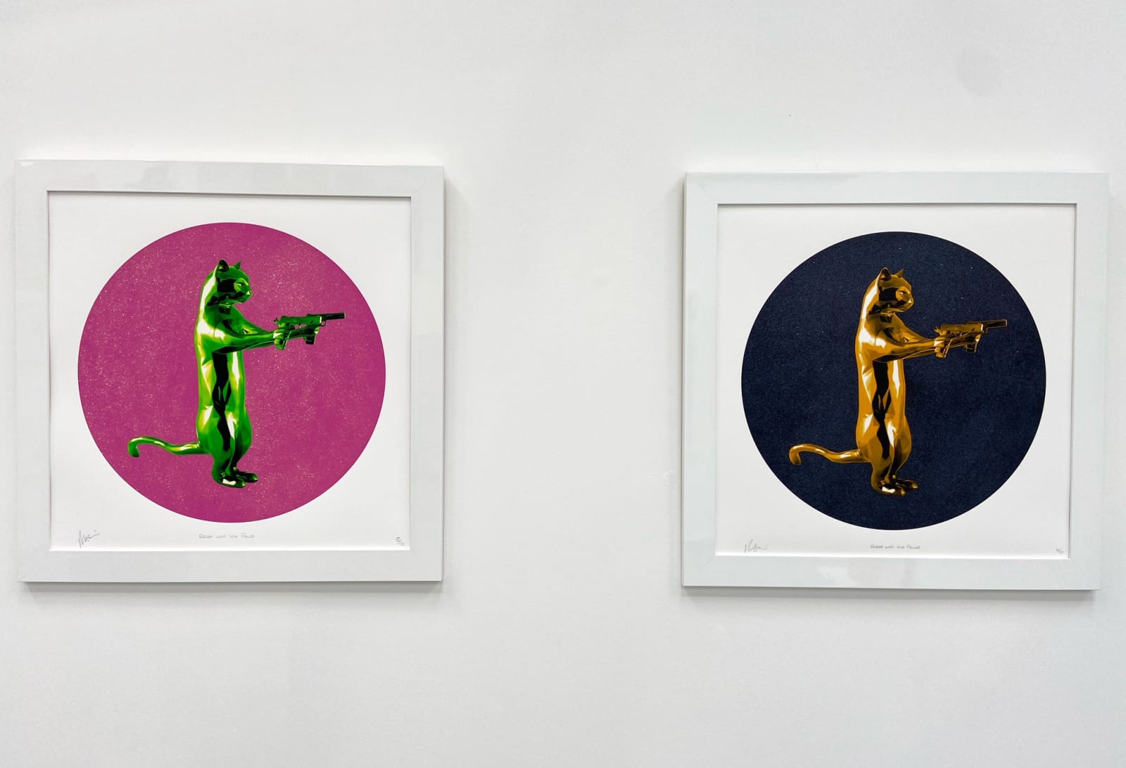 Gold & black rebel with the paws cat glitter sculpture print holding guns framed on the wall