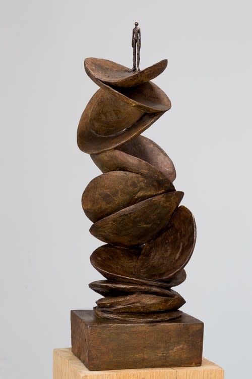 Leaves sculpture with small bronze man on top