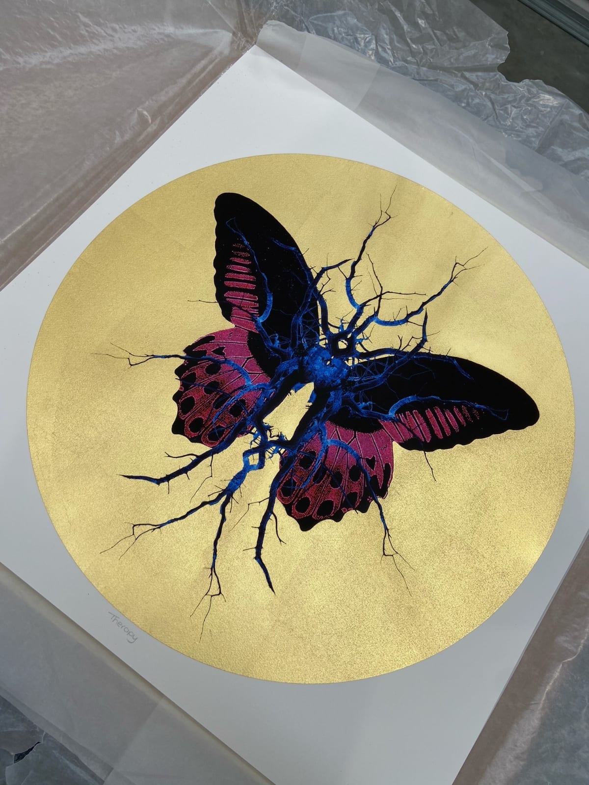 Purple, black & blue electric butterfly on gold leaf background circular background