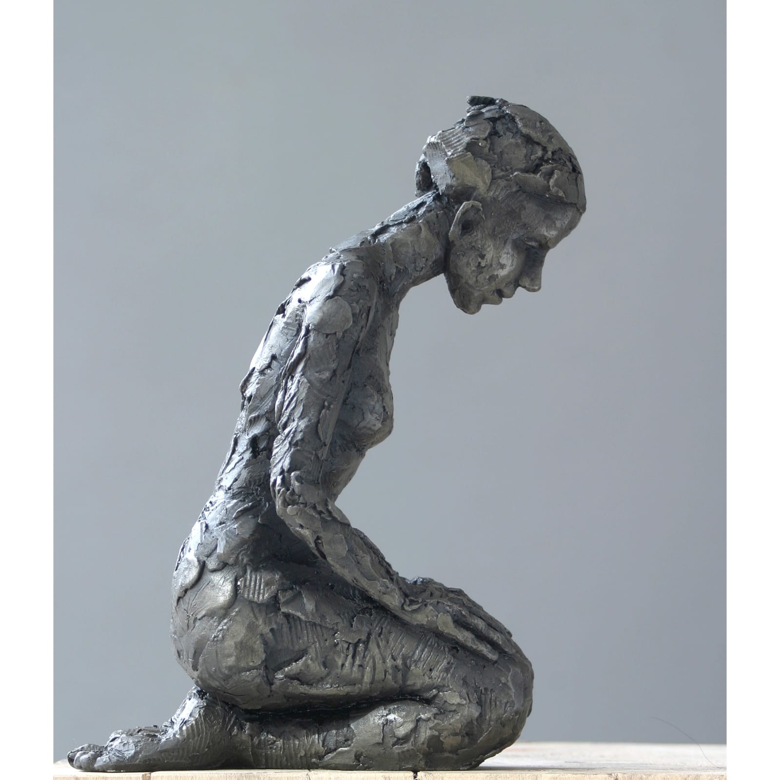 Kneeling iron resin sculpture