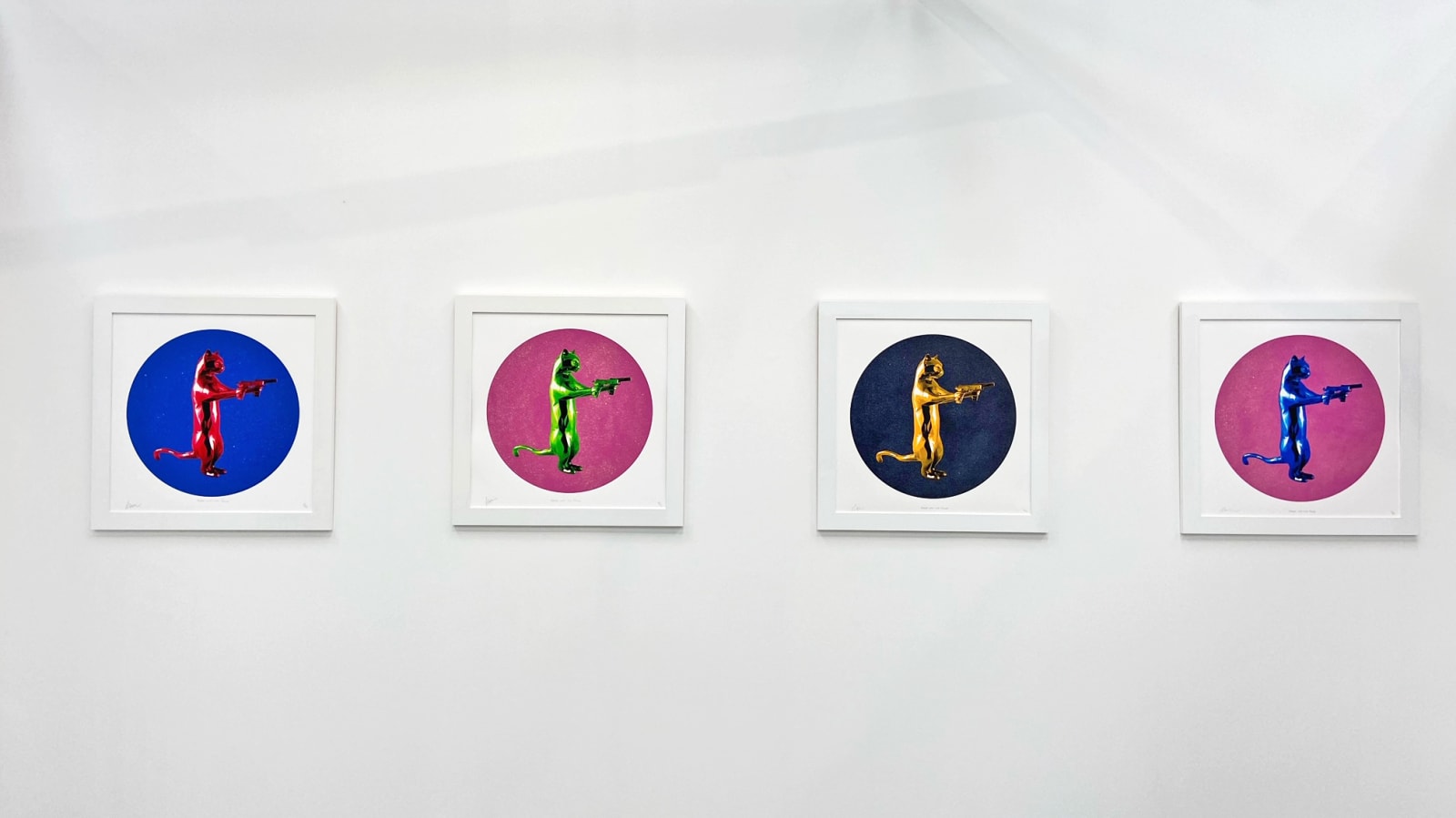 Gold & black rebel with the paws cat glitter sculpture print holding guns framed on the wall