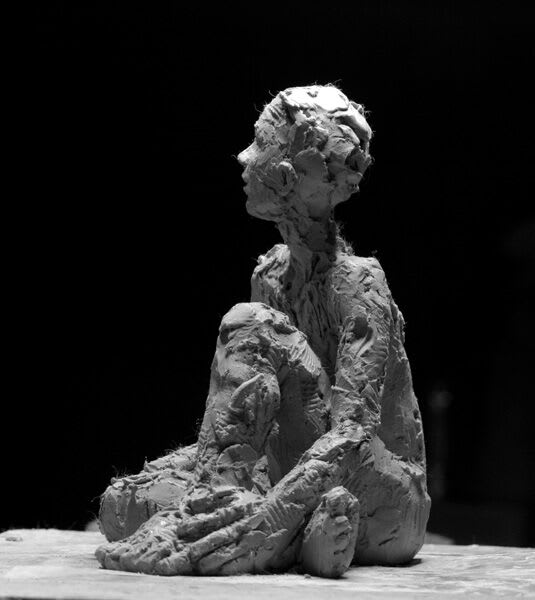 Seated female iron resin sculpture