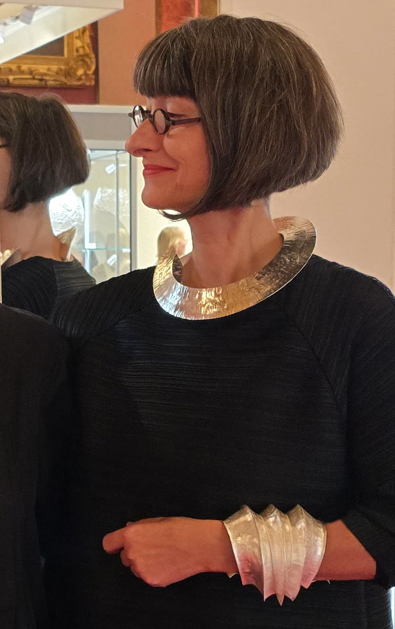 ute decker wearing one of her sculptural necklaces at Goldsmiths' Fair