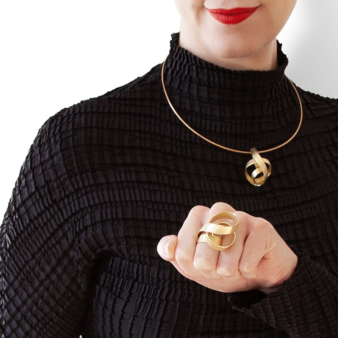 Sculptural ring and pendant – curling crest of a wave – in 18 kt Fairtrade Gold by ethical jewellery artist Ute Decker