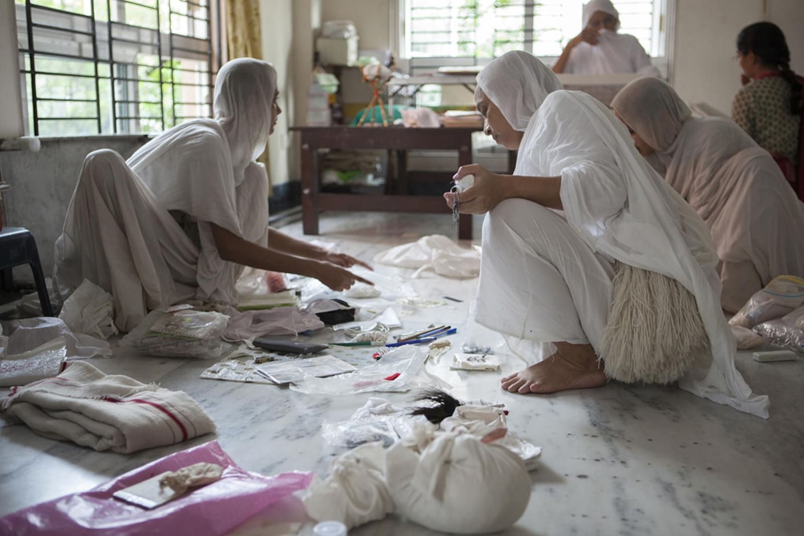 Briana Blasko, Swetamber Jain nuns sorting through the last possessions Kolkata, 2014