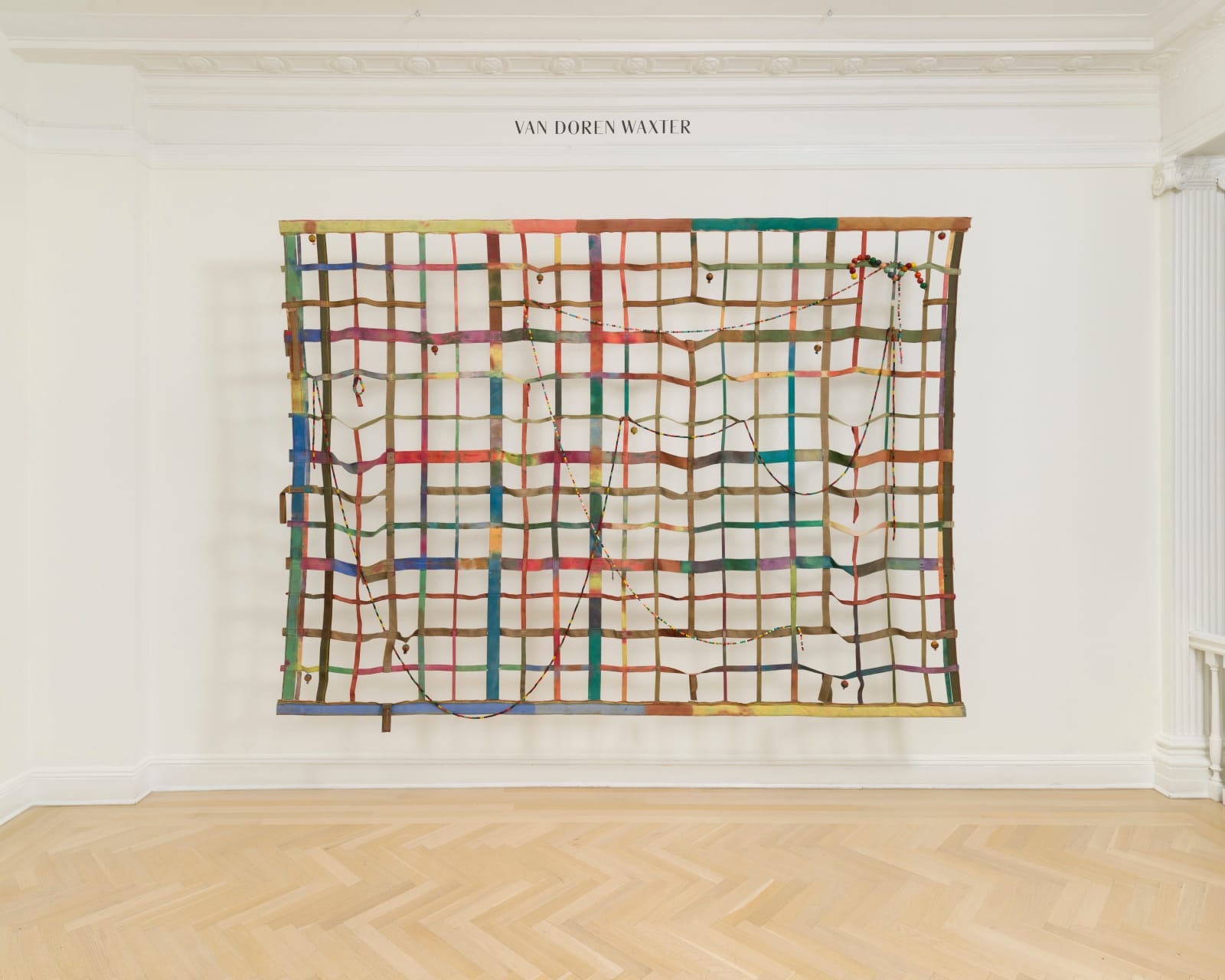 a large gridded painting hanging off the wall