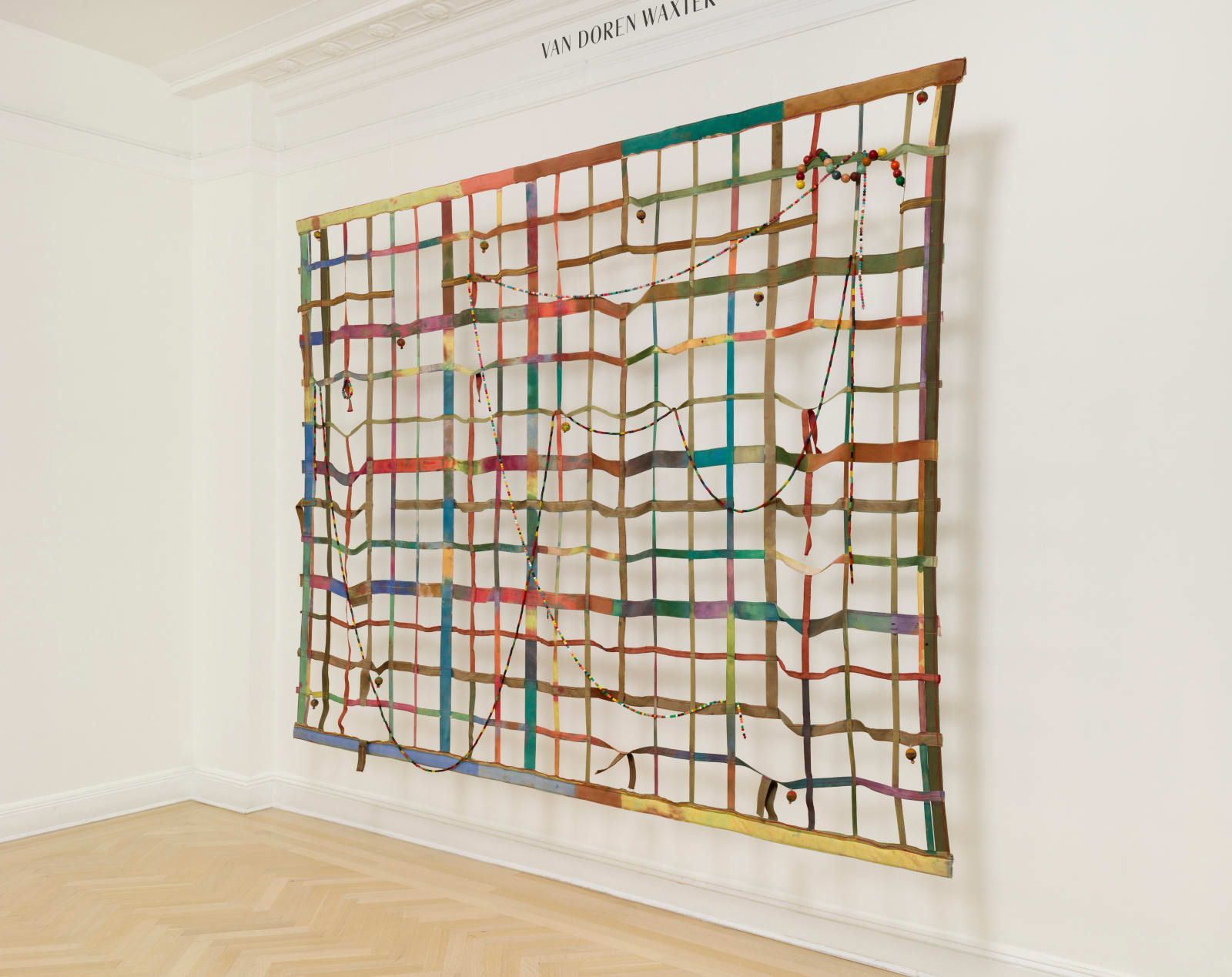 a large gridded painting hanging off the wall