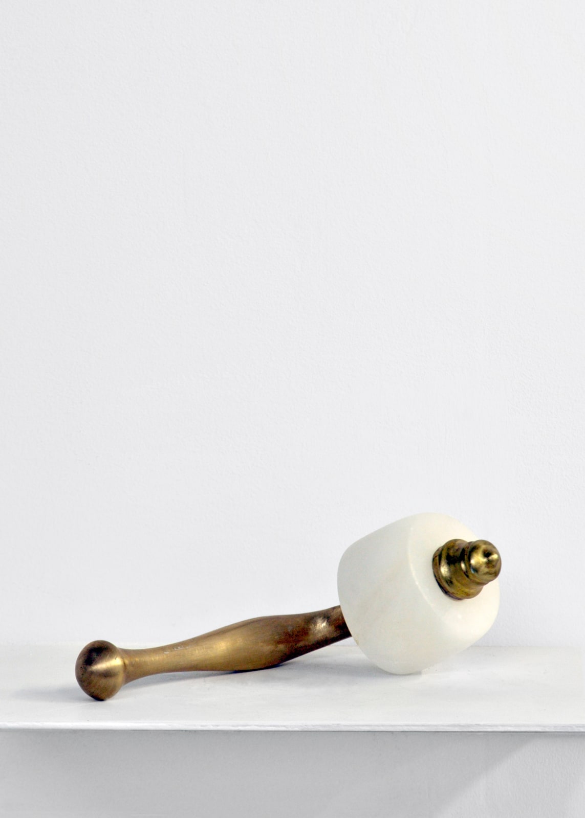 Contemporary minimalist sculpture made of stone and metal that resembles an ambiguous artifact