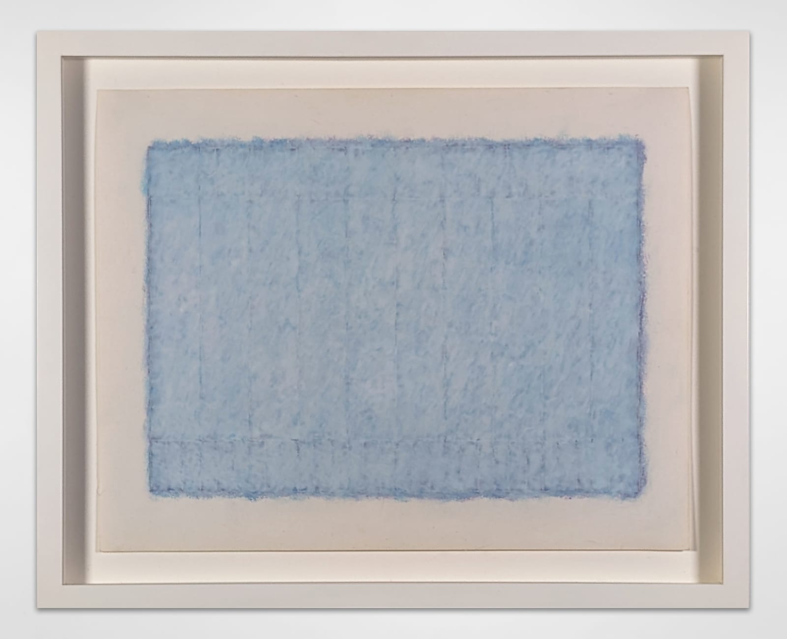 White framed oil-wax, chalk, and pencil artwork of a blue rectangle with darkened edges with faint striations delineating it into two sections
