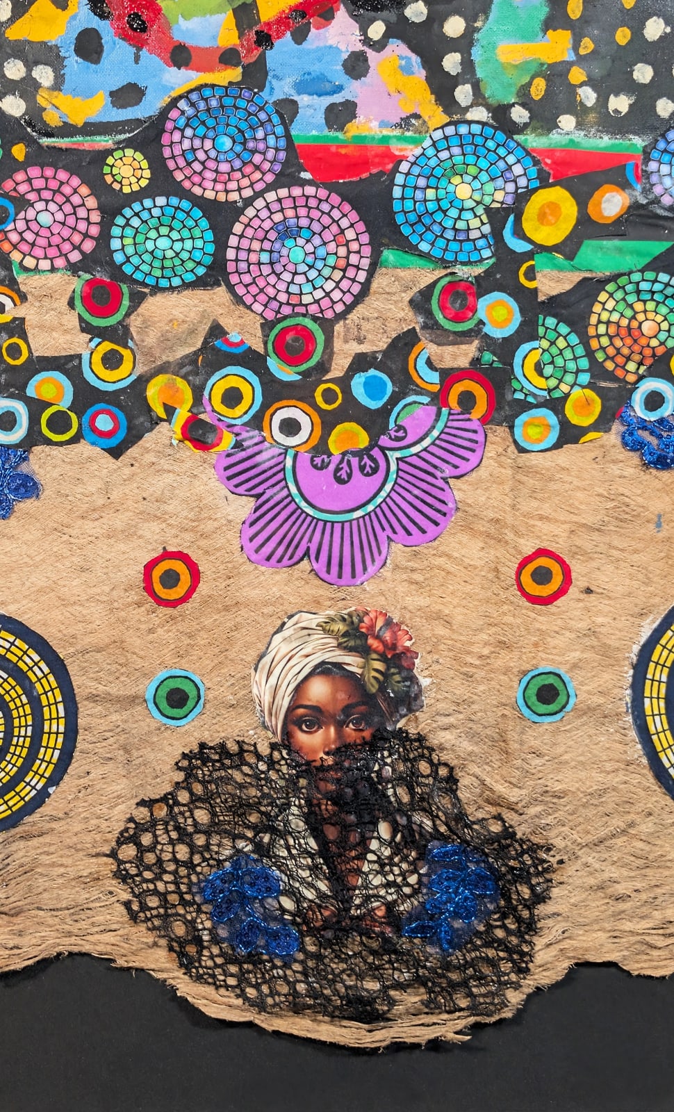 Detail of a colorful artwork comprised of oil and patterned fabric on canvas in a