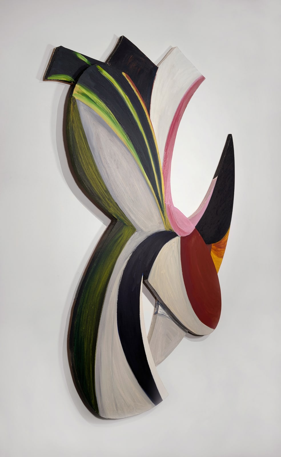 a colorful abstract painting on irregularly shaped wood panels assembled in a geometric formation with negative space hangs on a white wall